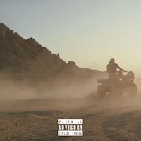 a man riding an atv in the desert